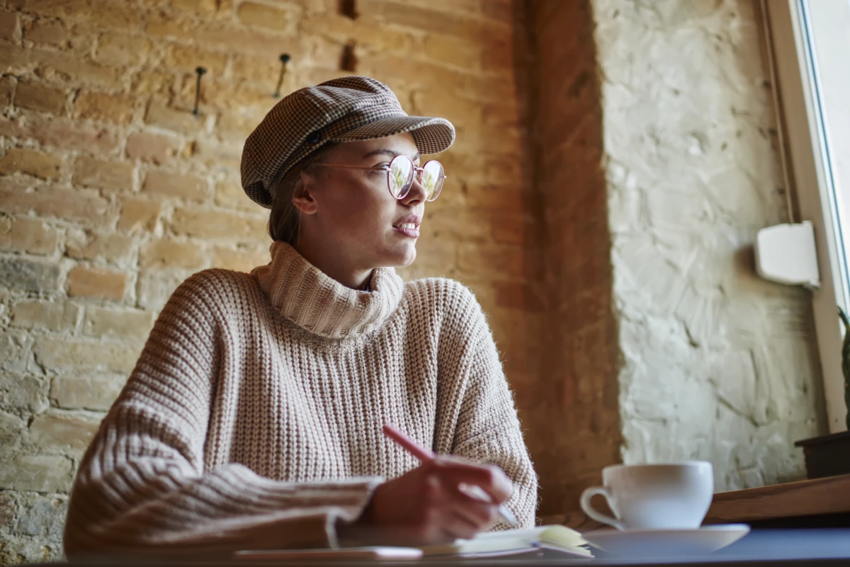 Woman writing obituary example.